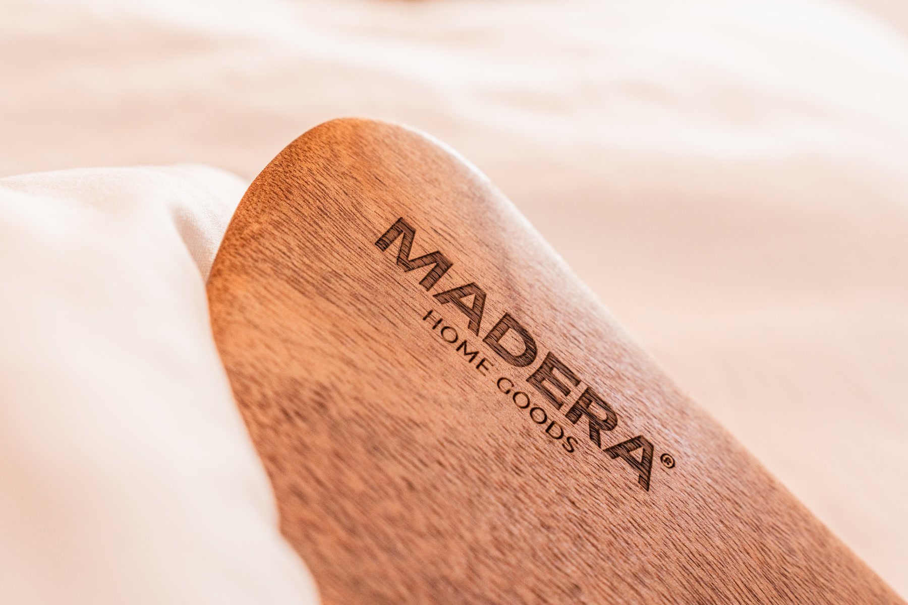 Close-up of the MADERA logo engraved into the acacia wood blade